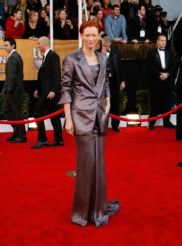 Tilda Swinton wearing a long gray dress underneath a gray blazer