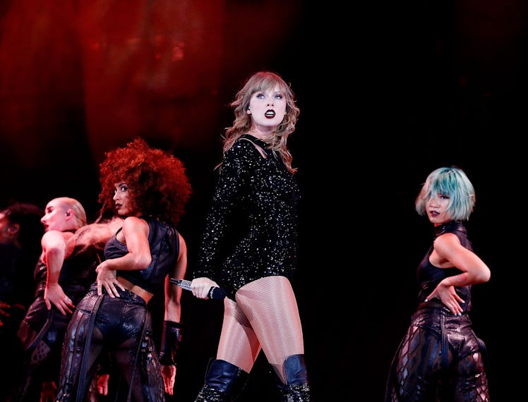 Taylor Swift in black on stage. 