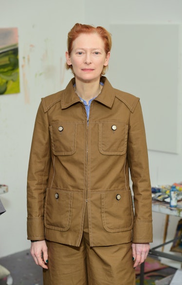 Tilda Swinton wearing a brown jacket and brown pants to match