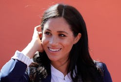 Meghan, Duchess of Sussex attends an Investiture for Michael McHugo the founder of 'Education for Al...