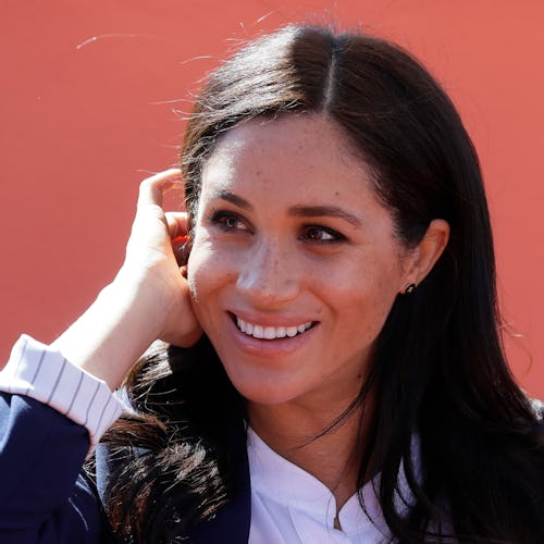 Meghan, Duchess of Sussex attends an Investiture for Michael McHugo the founder of 'Education for Al...