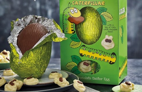 A chocolate egg in green foil with white caterpillar chocolates and a green-foil-wrapped egg in a gr...