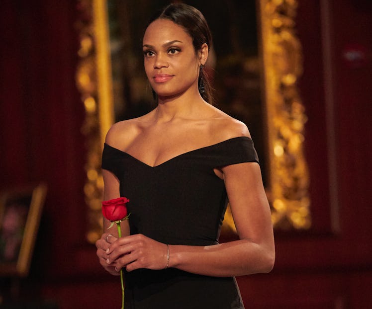 Bachelorette Michelle Young holding a red rose