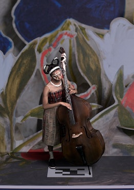 A model in a Simone Rocha x HM dress playing a double bass