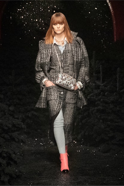 A female model walking in a grey coat