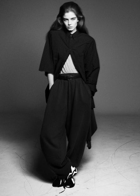 Merlijne Schorren wears a Balenciaga shirt and sweatpants;  the Row belt (throughout); Reebok sneake...