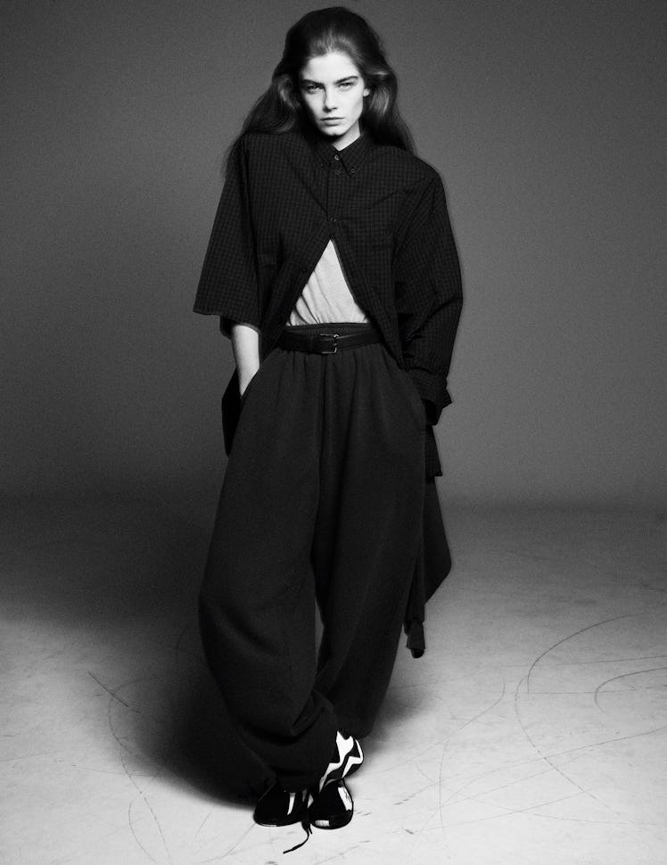 Merlijne Schorren wears a Balenciaga shirt and sweatpants;  the Row belt (throughout); Reebok sneake...