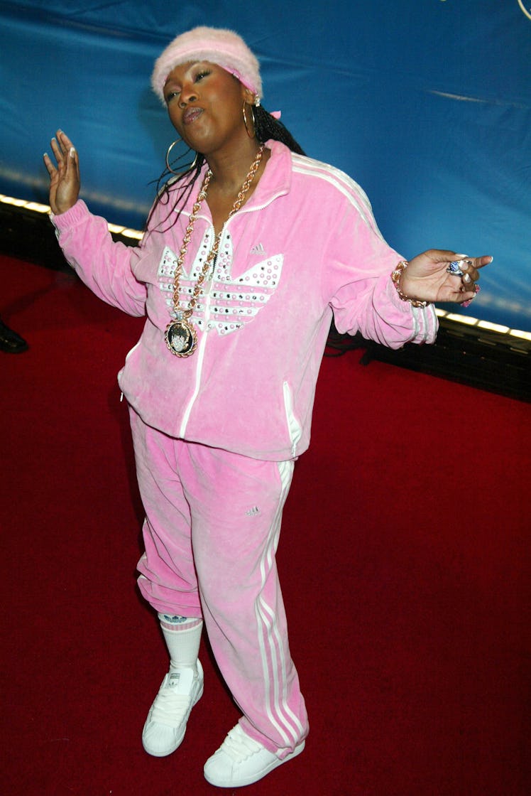 Missy Elliott on red carpet in velvet pink Adidas hoodie with gold chains around her neck