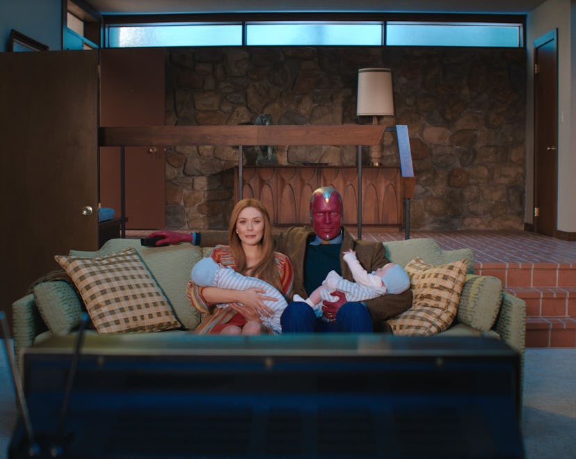 A screenshot with Wanda and Vision holding their twins in WandaVision