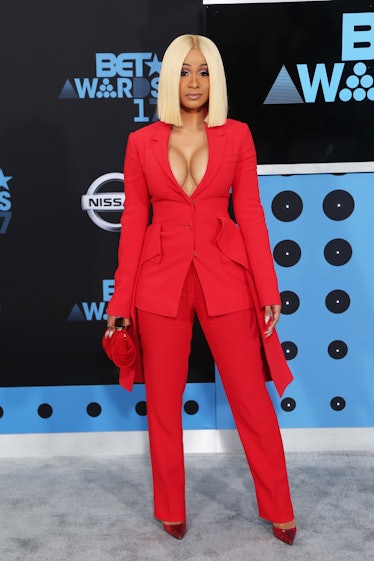 Cardi B in a red suit and blonde hair.