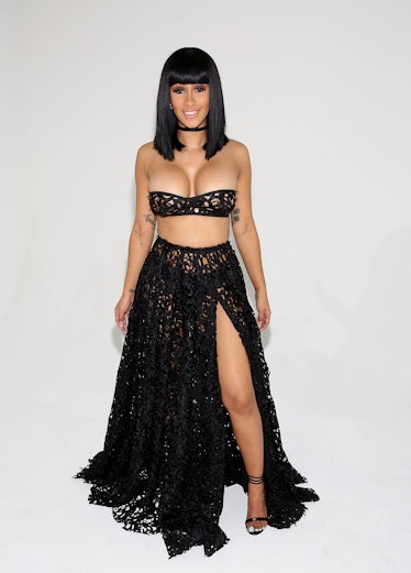 Cardi B in very small halter top and very long black skirt.