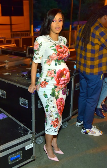 Cardi B, pregnant in floral gown.