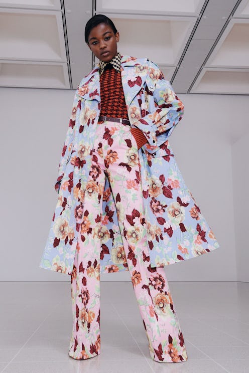 Model wearing floral coat and pants in Victoria Beckham's Fall/Winter 2021 collection