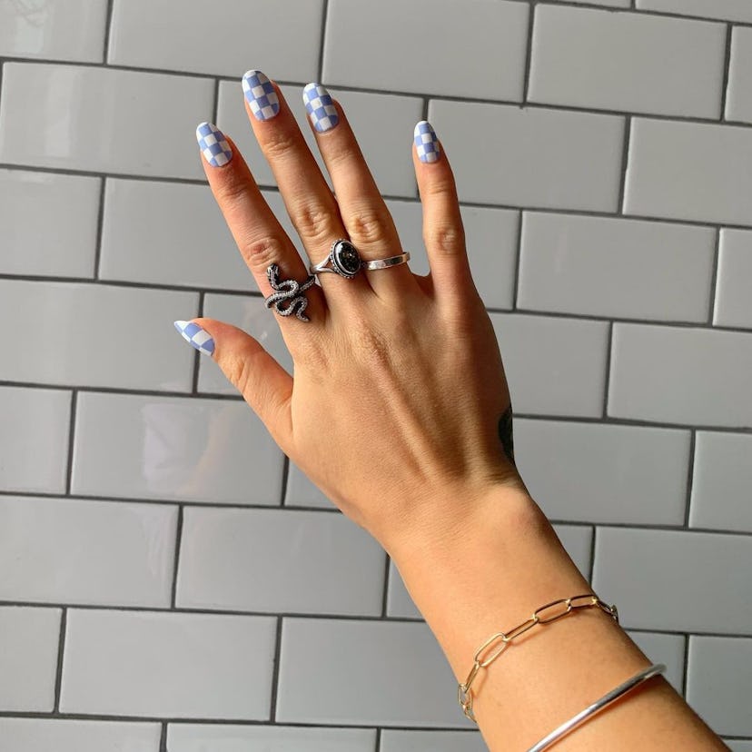 A spring manicure with light blue and white checkerboard nails 