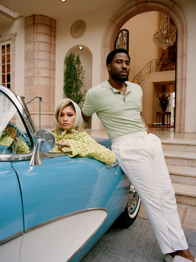 Zendaya in a vintage car in a green blouse and a head scarf with Washington next to her in a green s...