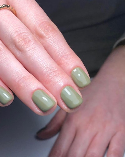 A spring manicure featuring green nails
