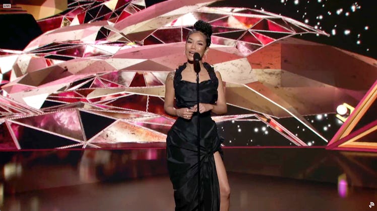 Jhene Aiko on stage wearing a black dress at the 2021 Grammys