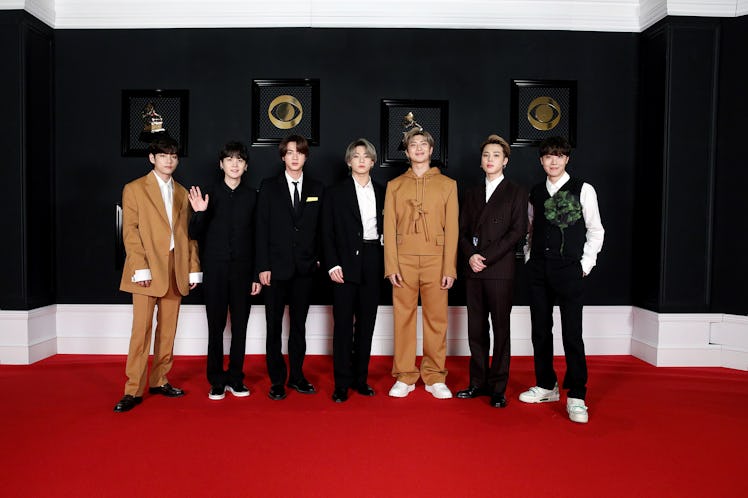 BTS on the red carpet wearing black and brown Louis Vuitton suits at the 2021 Grammys