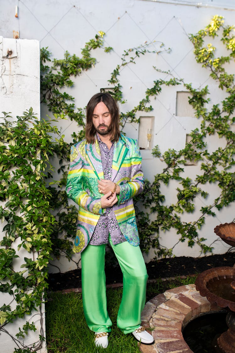Kevin Parker wearing green silk pants with a colorful blazer at the 2021 Grammys
