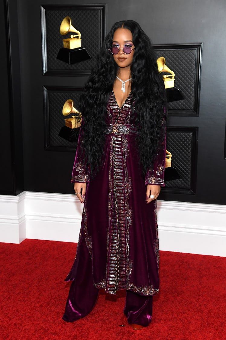 H.E.R on the red carpet wearing a burgundy Dundas gown and Bonni Clyde sunglasses at the 2021 Grammy...