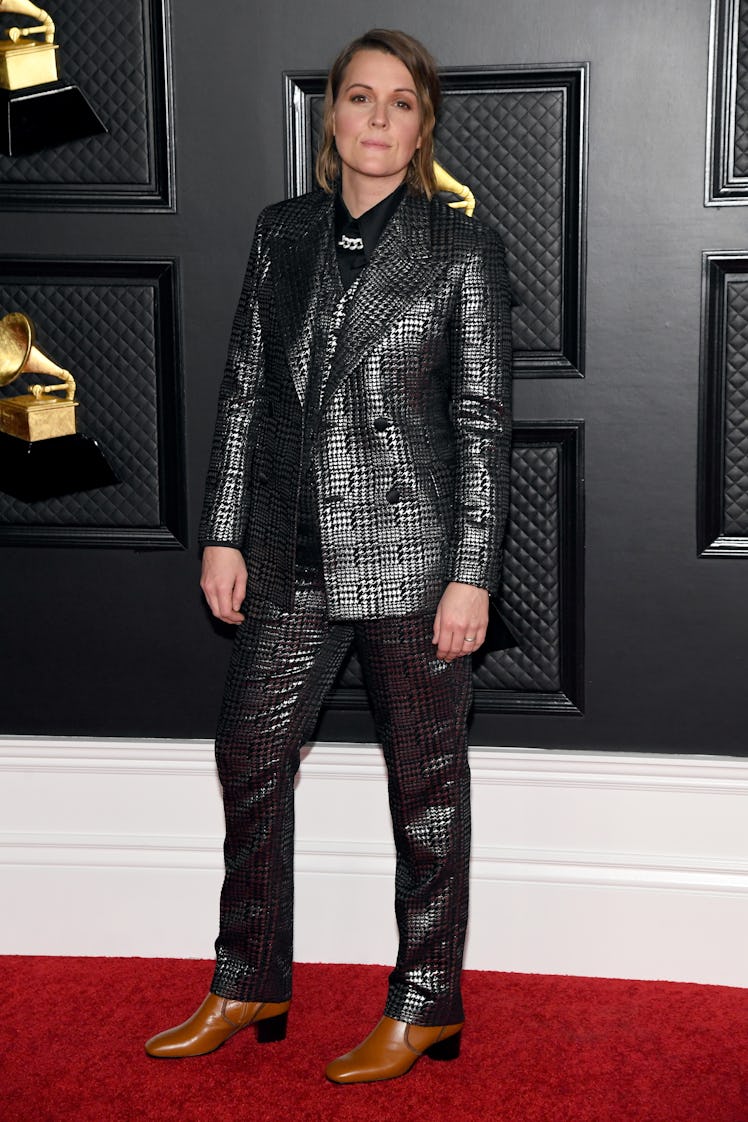 Brandi Carlile on the red carpet wearing a silver and black striped suit at the 2021 Grammys