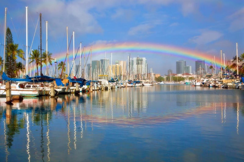 Rainbow over Honolulu Harbor with what appears to be its reflection. However, the reflected bow is n...