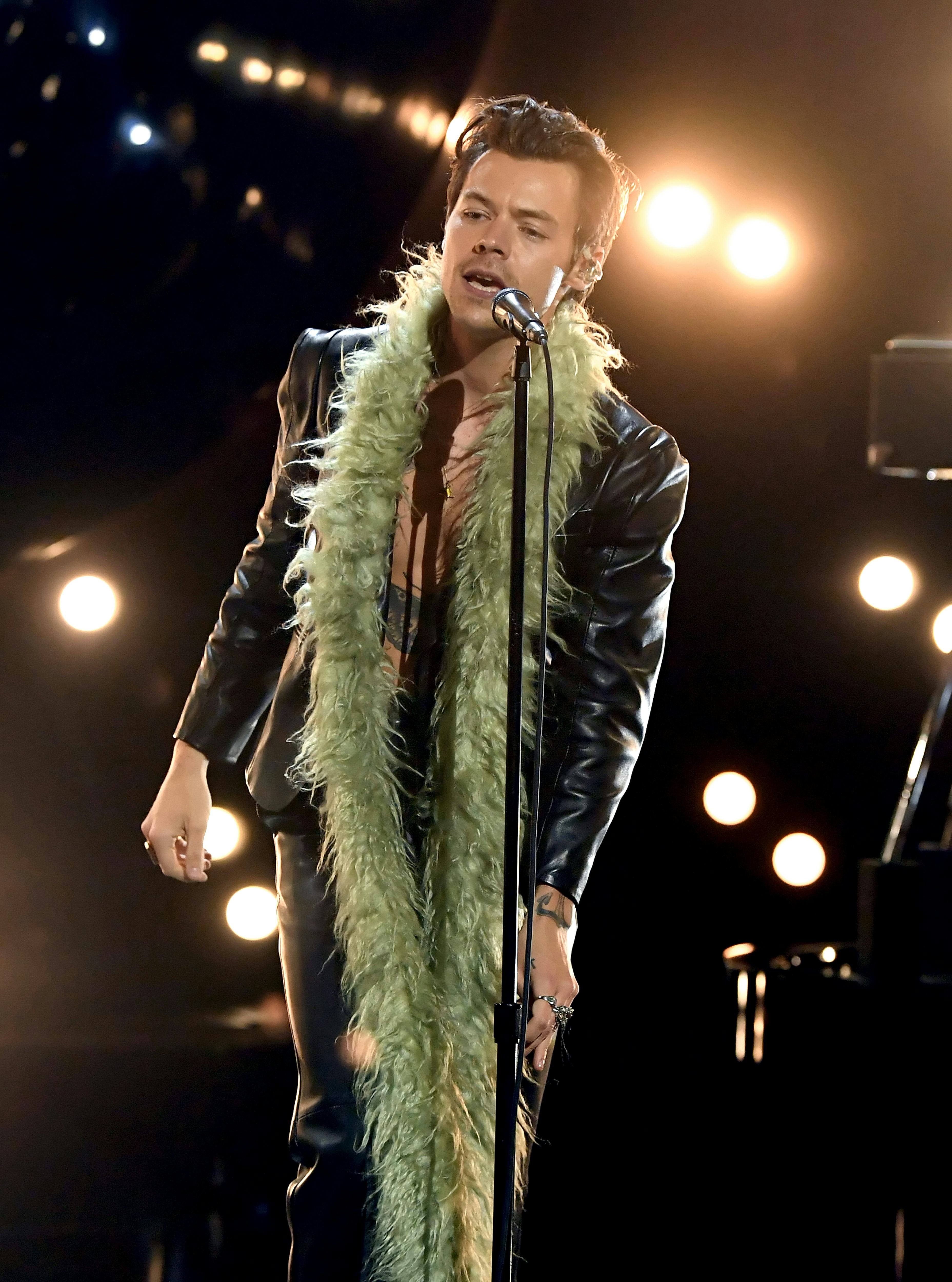 Harry Styles in green boa. 