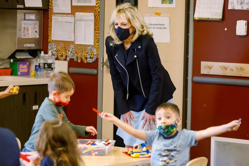 U.S. First Lady Jill Biden wears Veronica Beard nylon moto jacket and colorblocked dress as she visi...