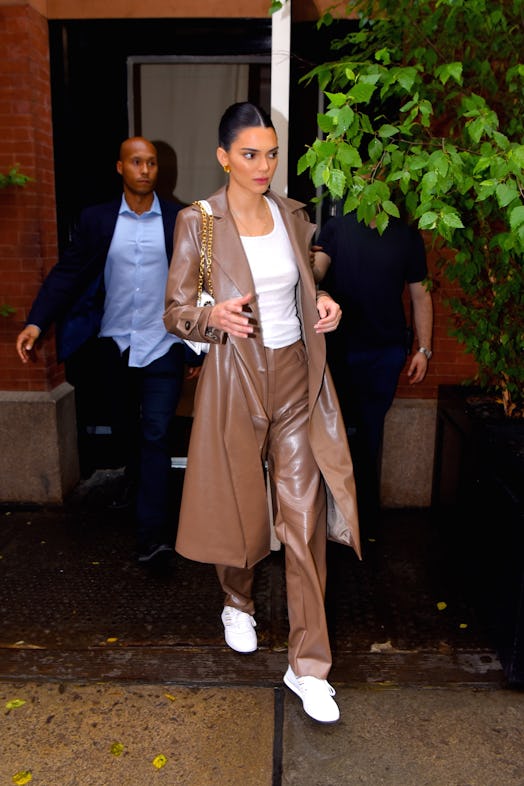 Kendall Jenner wears a brown leather matching set.