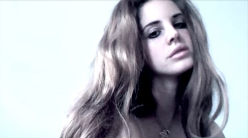 A screen grab from "Video Games." It's a shot of Lana Del Rey gazing into the camera with thick eyel...