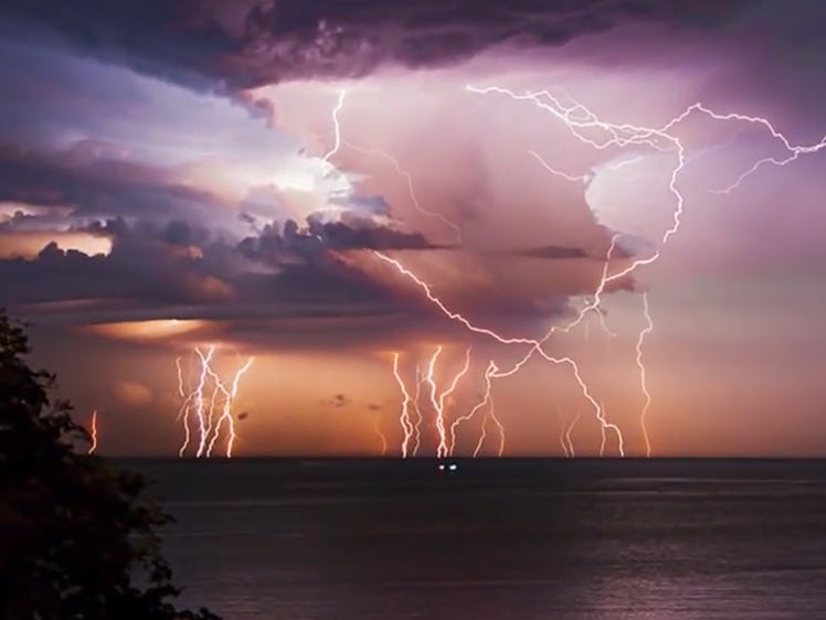 An image of lightning striking over a body of water