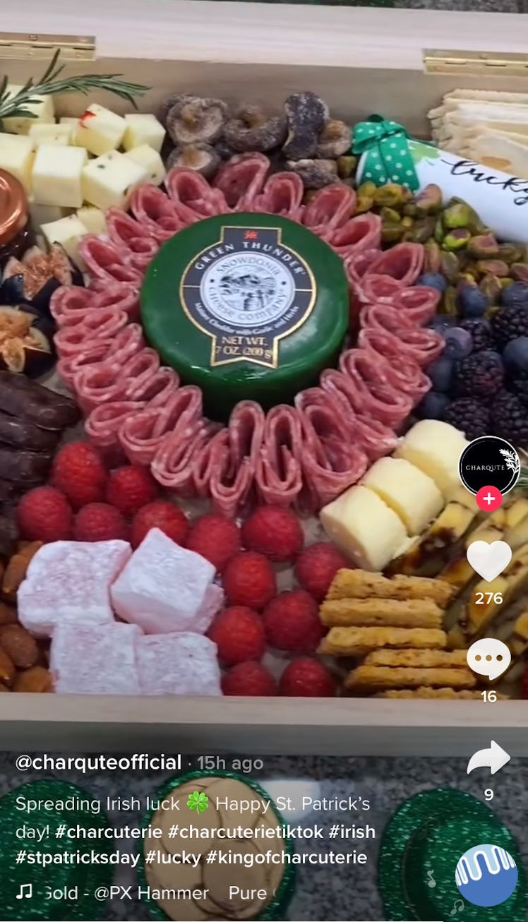 A St. Patrick's Day charcuterie board with green cheese and jalapeño spread sits on the counter. 