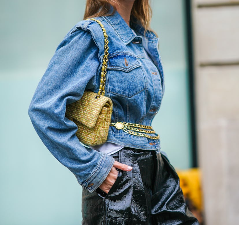 Natalia Verza aka Mascarada wears a white t-shirt, a blue denim jacket from Frankie Shop, a golden c...