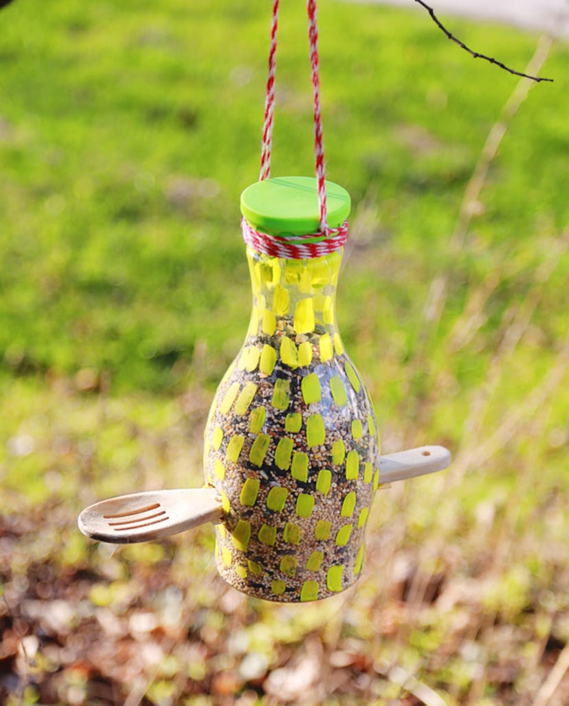 A bird feeder made out of a recyclable bottle.