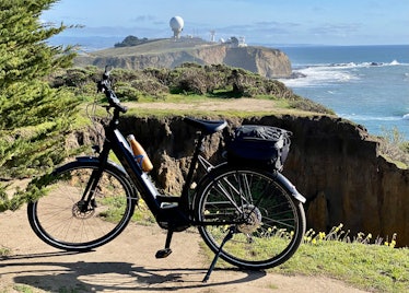 Rae-Dupree’s e-bike and view of the ocean from a hill 