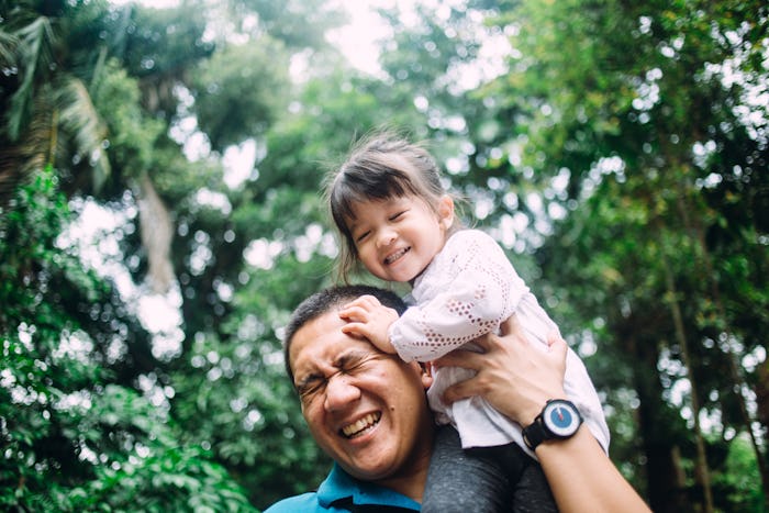 daughter sitting on dad's shoulders 