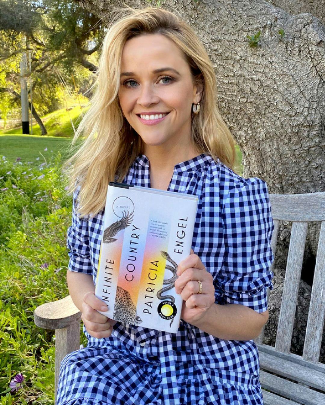 Reese Witherspoon holding March 2021 bookclub pick.