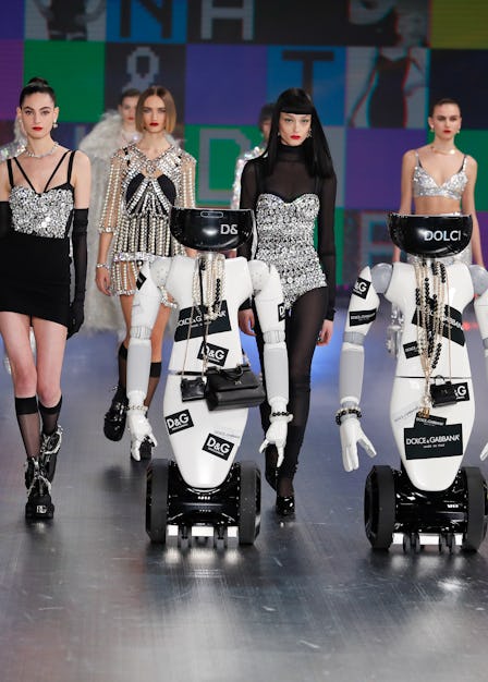 Several models walking behind robots at Dolce & Gabbana's Fall 2021 Runway