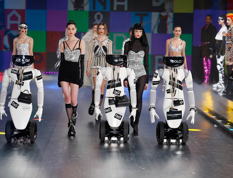 Several models walking behind robots at Dolce & Gabbana's Fall 2021 Runway