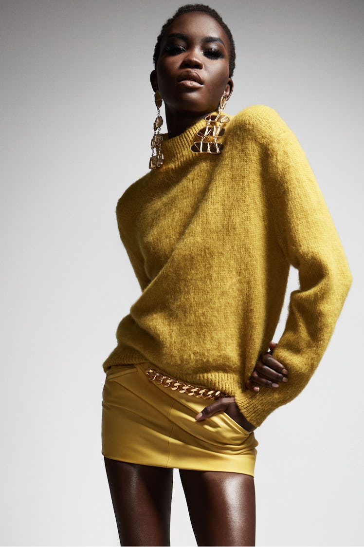 A model in a yellow sweater and yellow skirt by Tom Ford