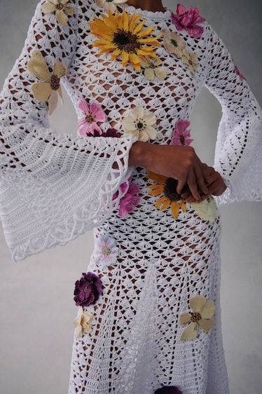 A model in a floral white knit dress by Oscar de la Renta