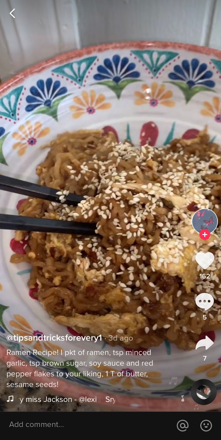 A TikToker films their version of a viral ramen recipe for the app.