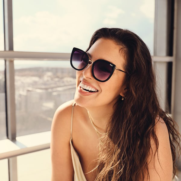 Ashley Graham wearing a pair of sunglasses from the Ashley Graham x Quay  collaboration.