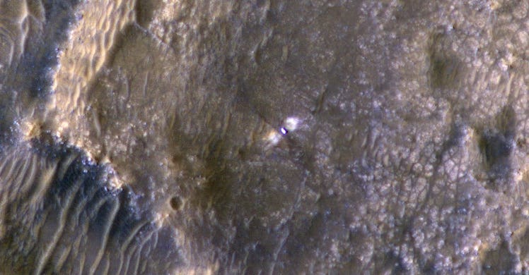 An image of the surface of Mars with the Perseverance rover shown in the center.