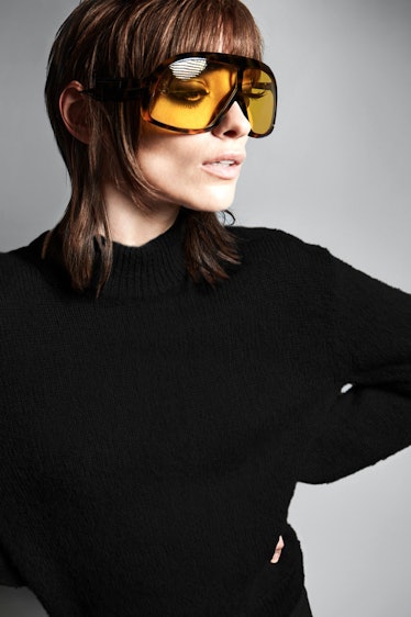 A model in yellow oversized sunglasses by Tom Ford 