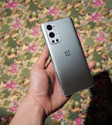 The OnePlus 9 Pro comes in three different colors: Morning Mist (shown) has a glossy glass back that...