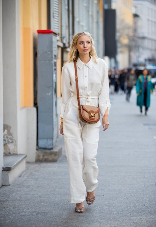 Leonie Hanne is seen wearing white button shirt and pants, brown bag outside Etro during Milan Fashi...