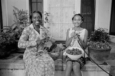 Viola Davis and her daughter Genesis sitting on the porch, peeling salad, and smiling