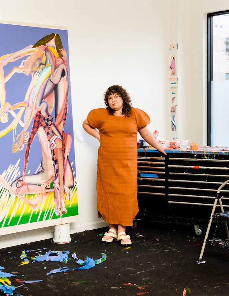 Christina Quarles in her studio in front of "New Moon" in an orange dress