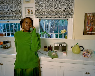 Viola Davis dressed in a green outfit talking on the retro green telephone